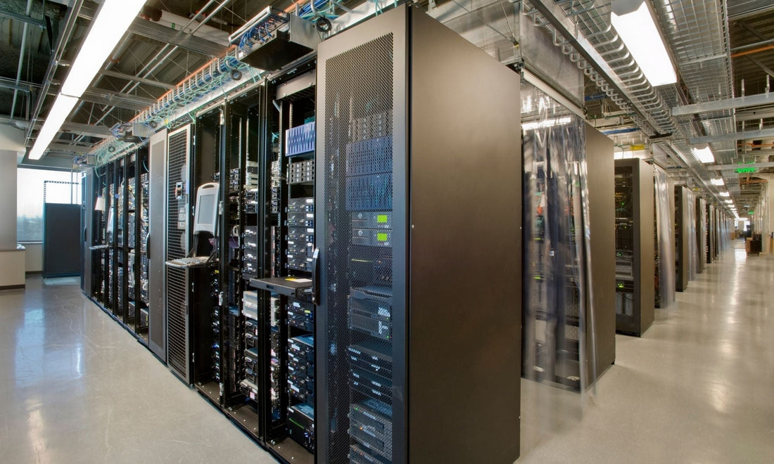 Modern data center aisle with server racks, overhead cable management, and monitored infrastructure